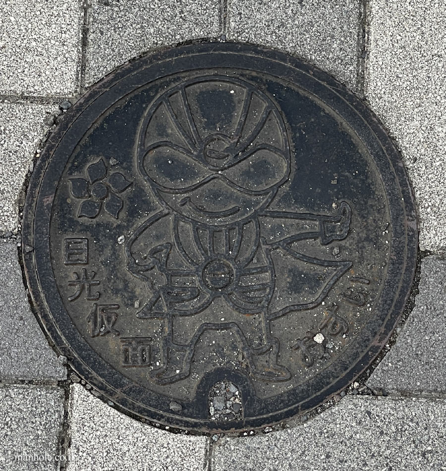 Nikko - Sewage - A manhole cover with the image of Nikko Kamen on it