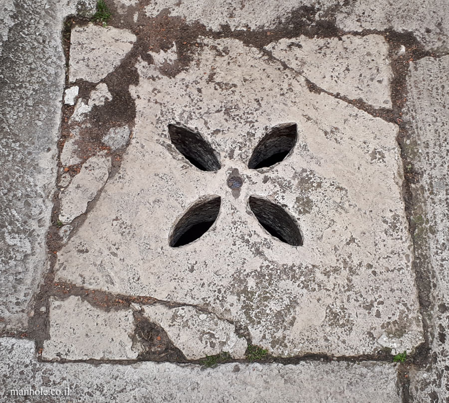 Rome - An old drainage cover with holes shaped like leaves