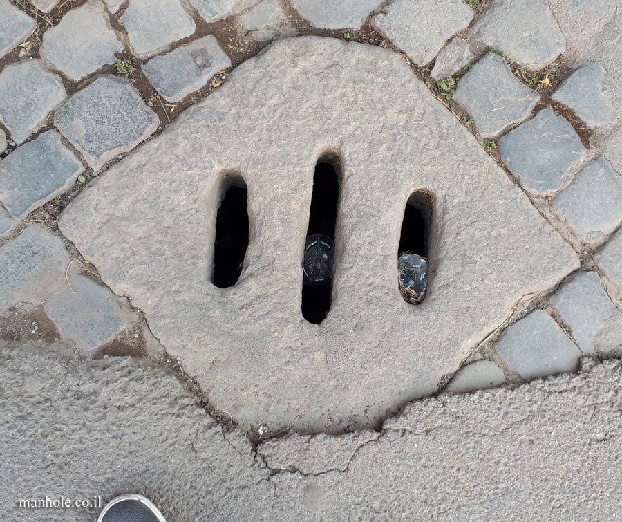 Rome - Ancient drainage cover with 3 grooves