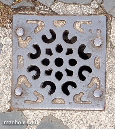Rome - Piazza Navona - A small drain cover with stylized grooves