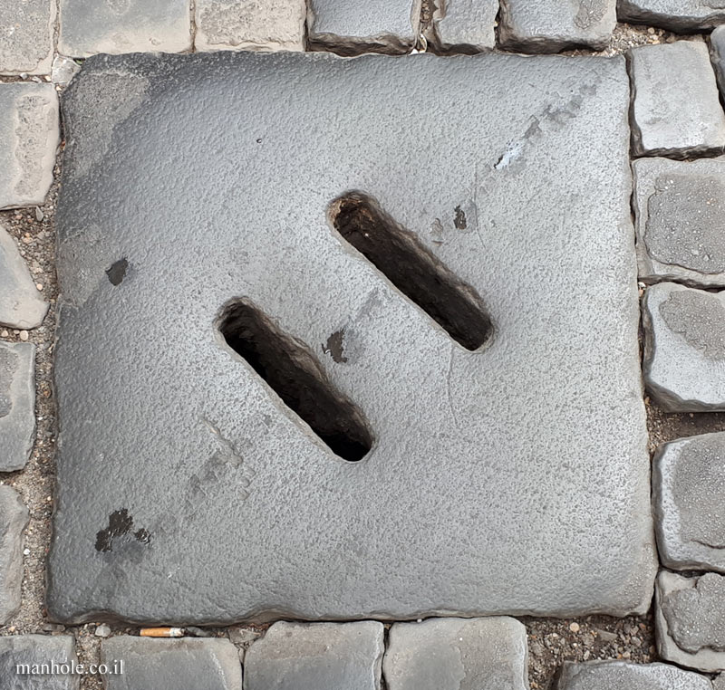 Rome - An old drainage cover with 2 grooves