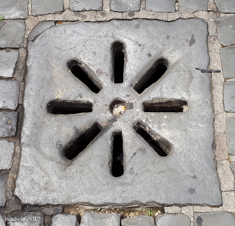 Rome - An old drainage cap with sun-shaped grooves
