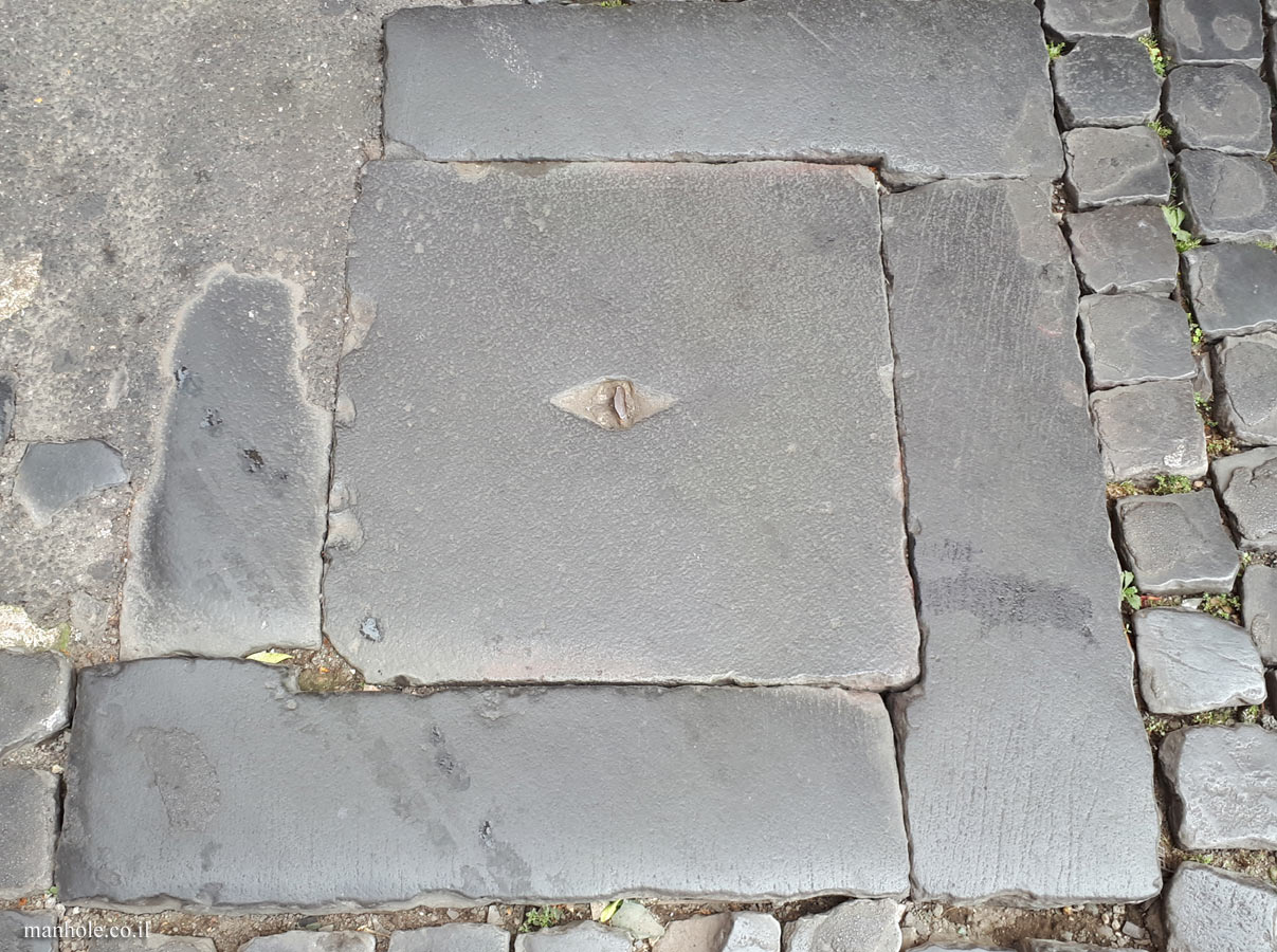 Rome - An old stone lid with a handle in the center