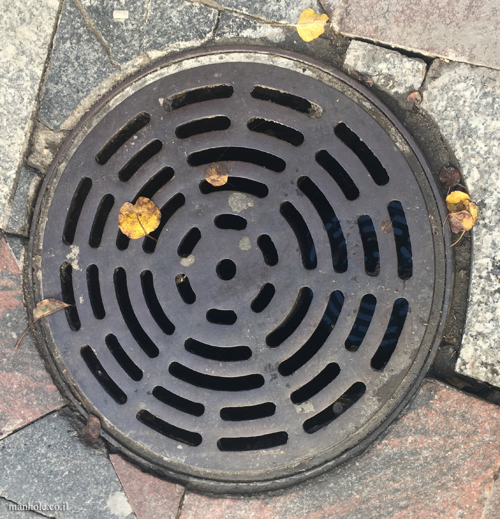 Madrid - A drainage cover  with circles of grooves