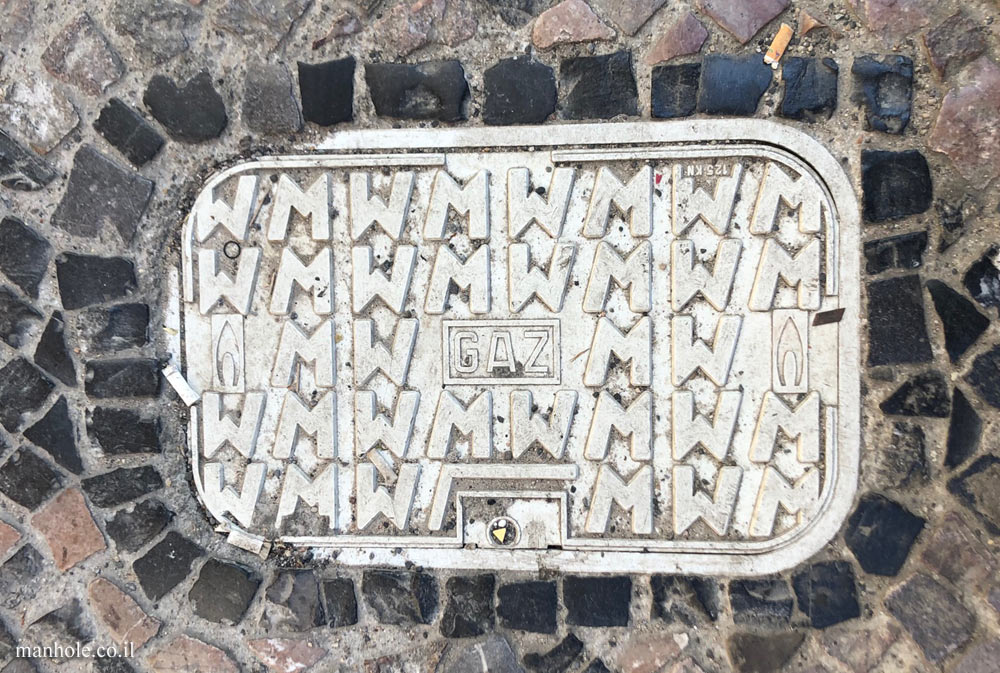 Prague - A gas cover with a background composed of the letters M and W