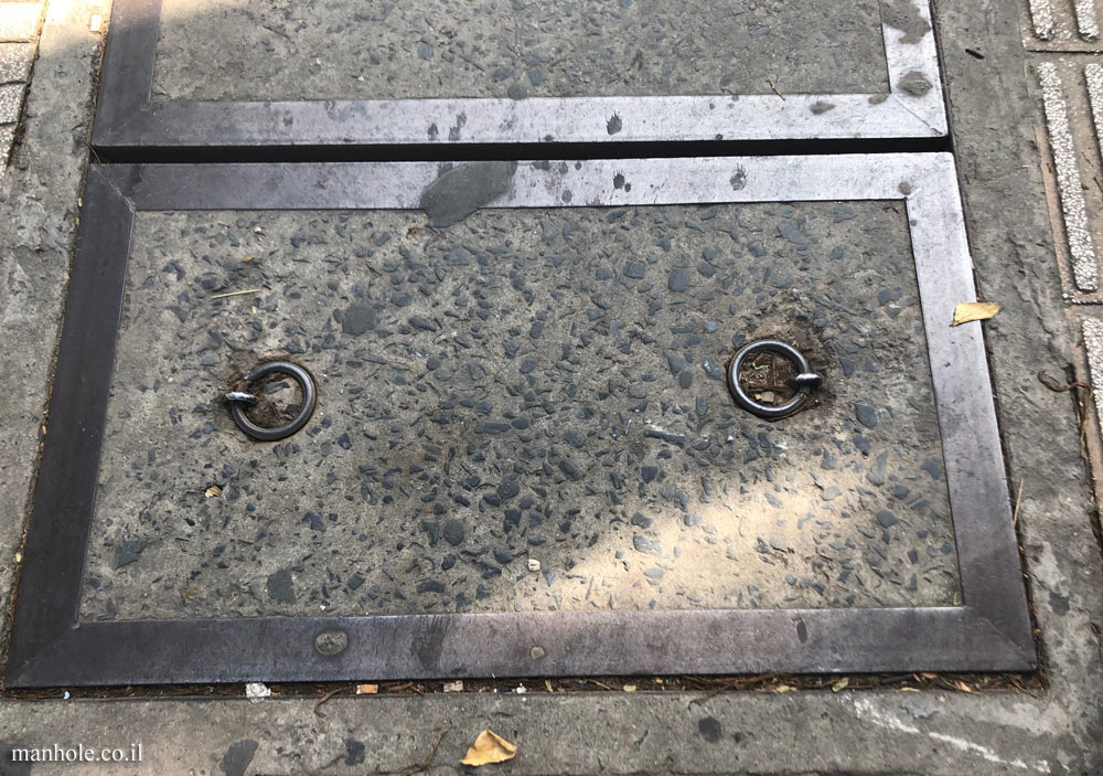 Ho Chi Minh City - a concrete cover with a wide metal frame and two lifting handles