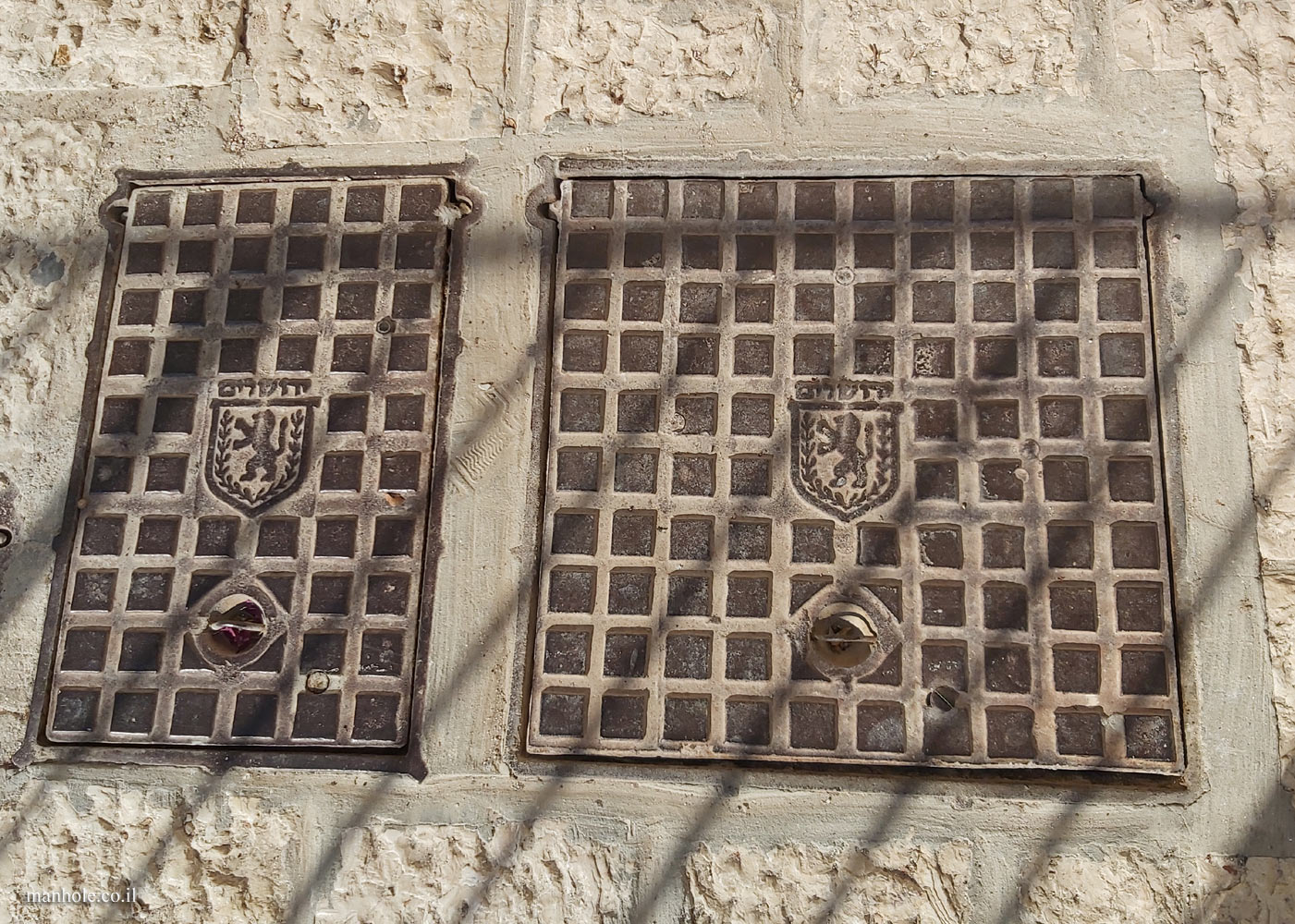 Jerusalem-Yemin Moshe - a cover with a background of squares and the city emblem in the center