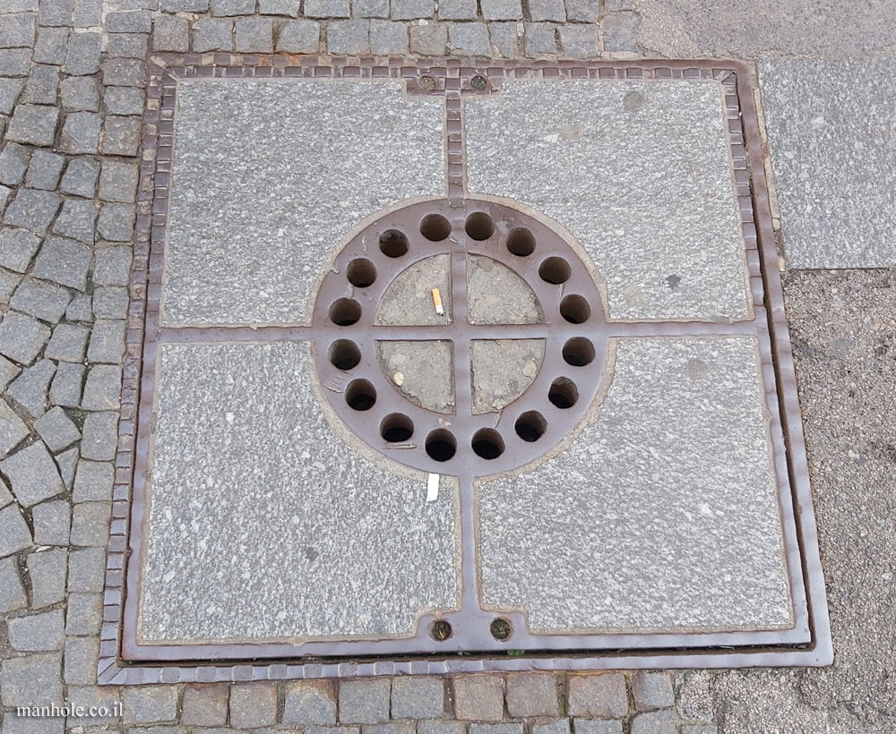 Vienna - a concrete lid with a perforated metal circle in the center