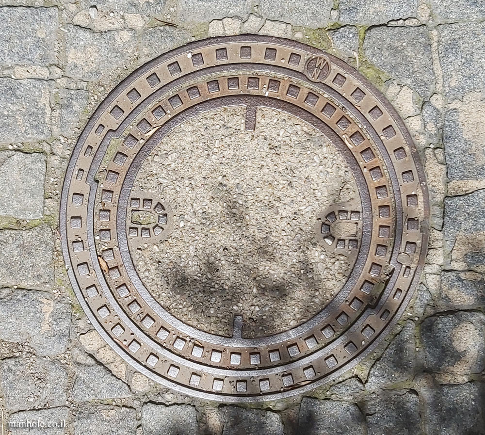 Vienna - a round concrete cover surrounded by a metal frame