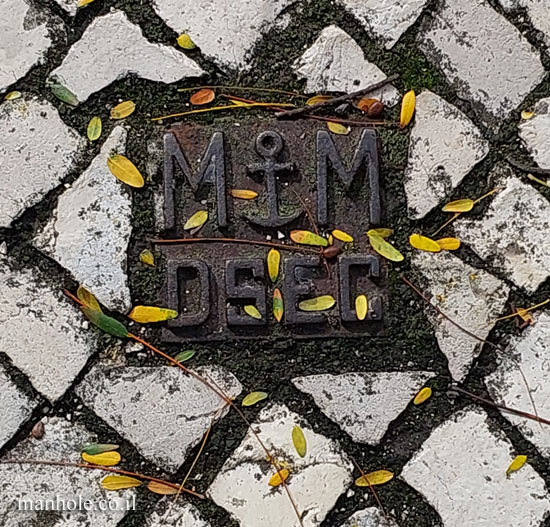 Lisbon - a tiny lid with two letters M and a symbol of an anchor between them