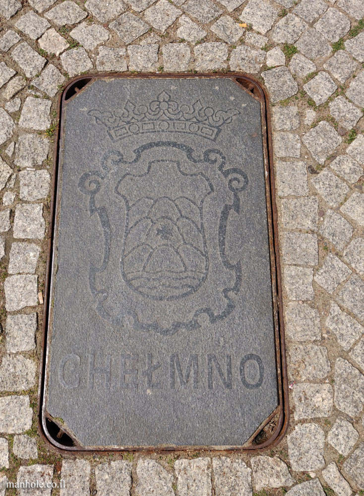 Chełmno - a concrete cover with the symbol of the city on it