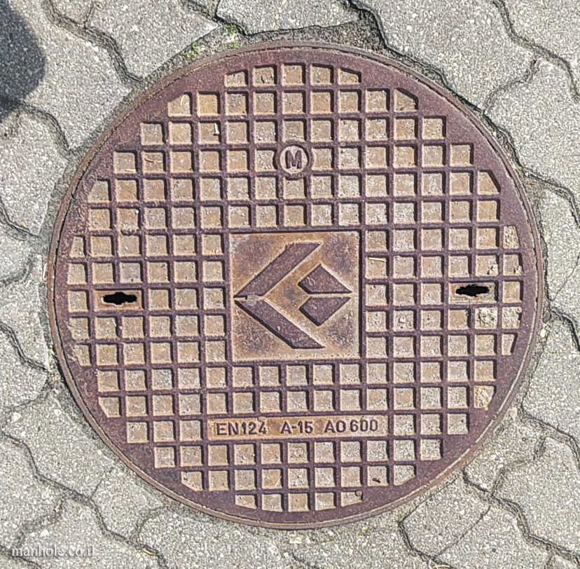 Warsaw - a round cover with a background of squares and a symbol in the center