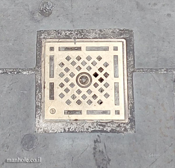 London - gilded drain cover